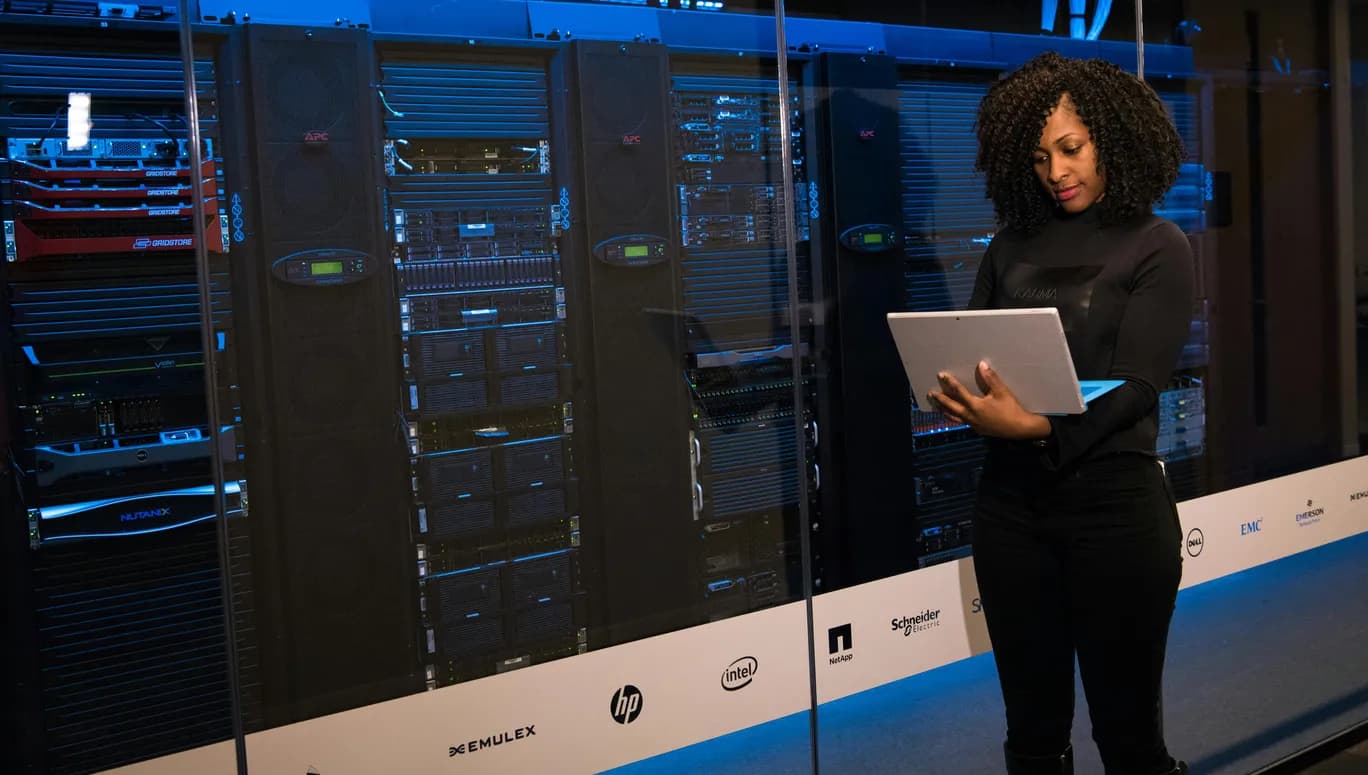 lady in front of large computing system with laptop