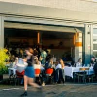 Bar Dancing Multipla people sitting on the terrace during the day