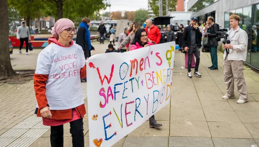 A couple  holding a banner at the women's march