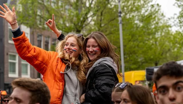 Two girls at Elandsgracht celebrating King's Day 2024.