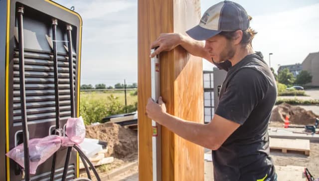 Man measuring for new charging station for electric vehicles.