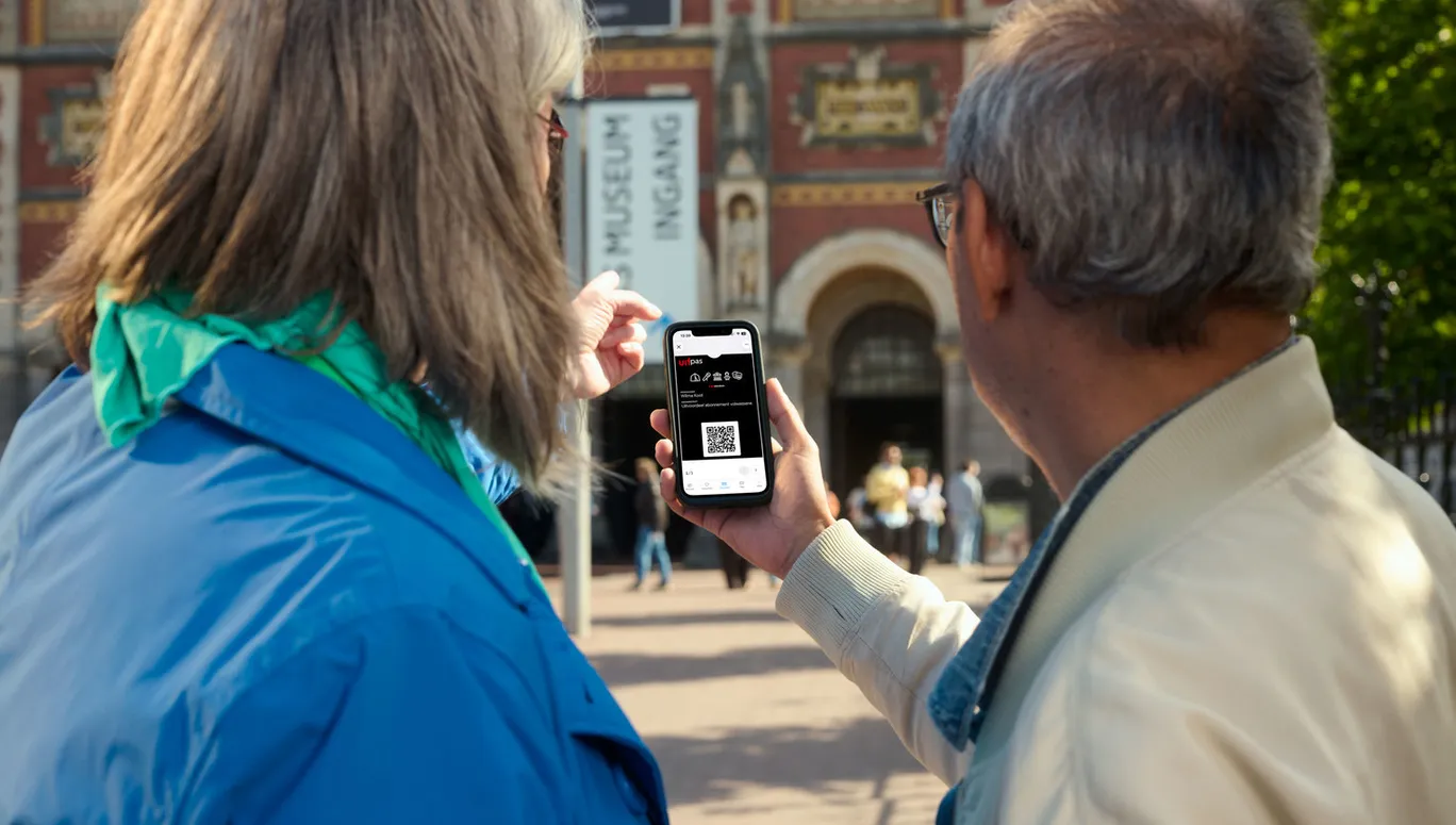 Closeup shot of the Uitpas app held by different people