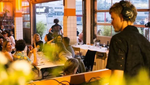 Bar Dancing Multipla DJ playing music while people having dinner