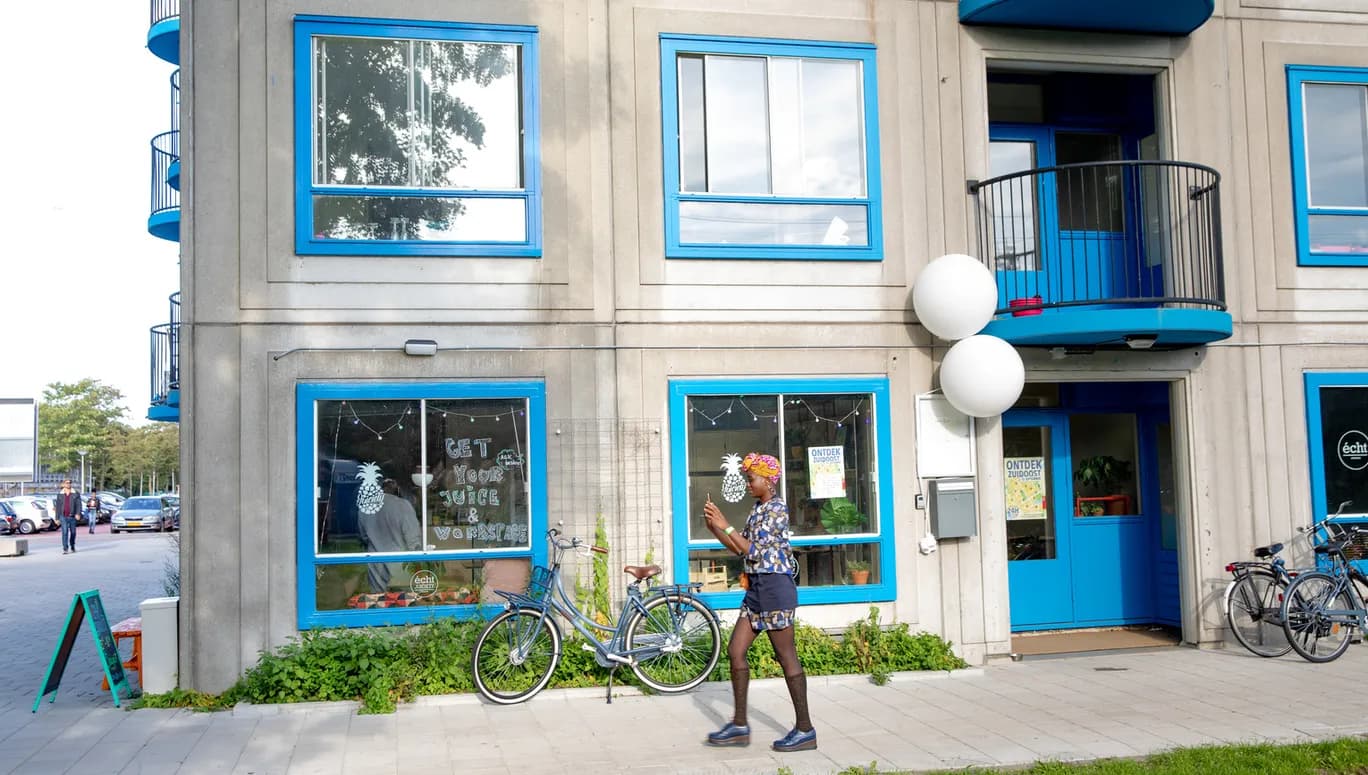 A woman walking infront of the Juicety building