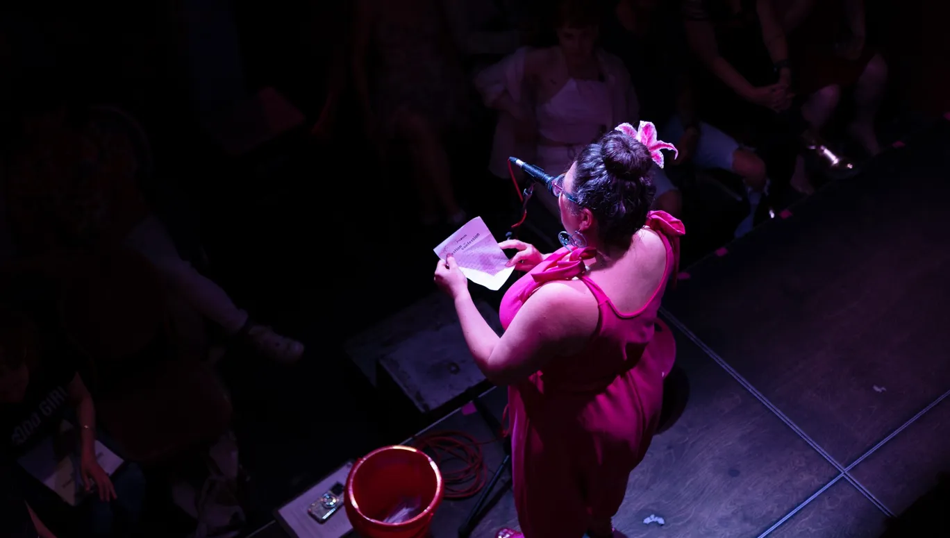 Comedian on stage at De Nieuwe Anita for Smut Slam queer comedy night