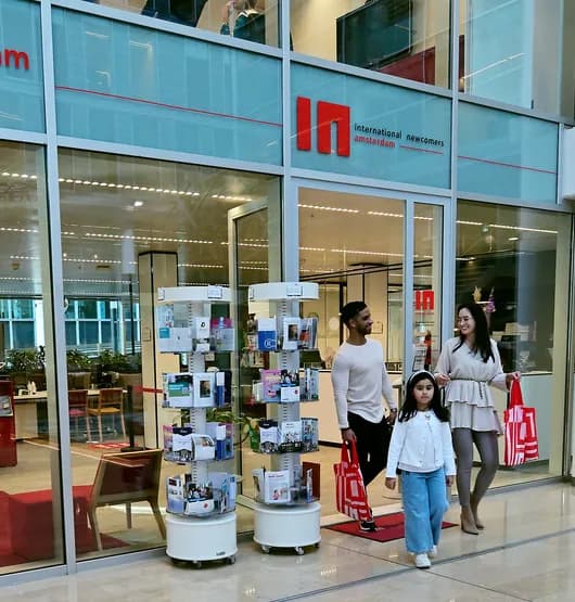 Family in front of the offices of INAmsterdam