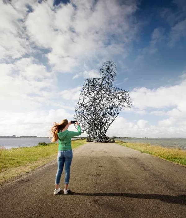 A woman making a picture of Exposure Landart Lelystad