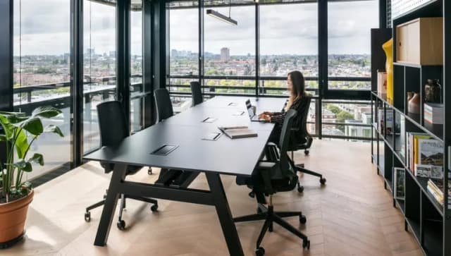Woman working on her laptop in a work space of The Social Hub Amsterdam City.