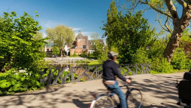 A person cycles through Oosterpark.
