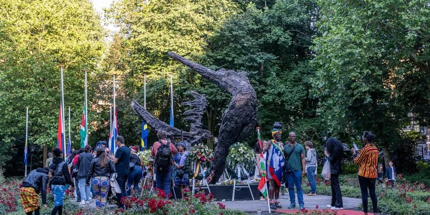 People gathering around the National Slavery Monument in the Oosterpark during Keti Koti Festival 2022.