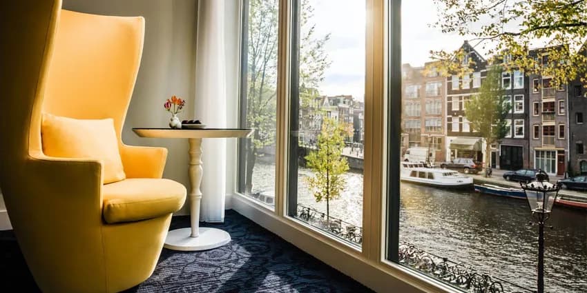 Chair at the window in hotel Andaz with view on the Prinsengracht.