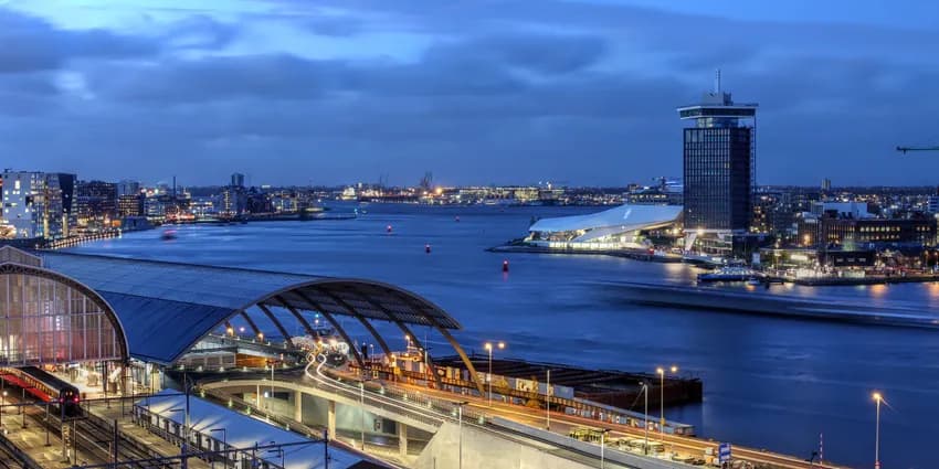 Skyline view of Amsterdam's waterfront facing the Ij River, with A'dam Toren and Amsterdam Eye.