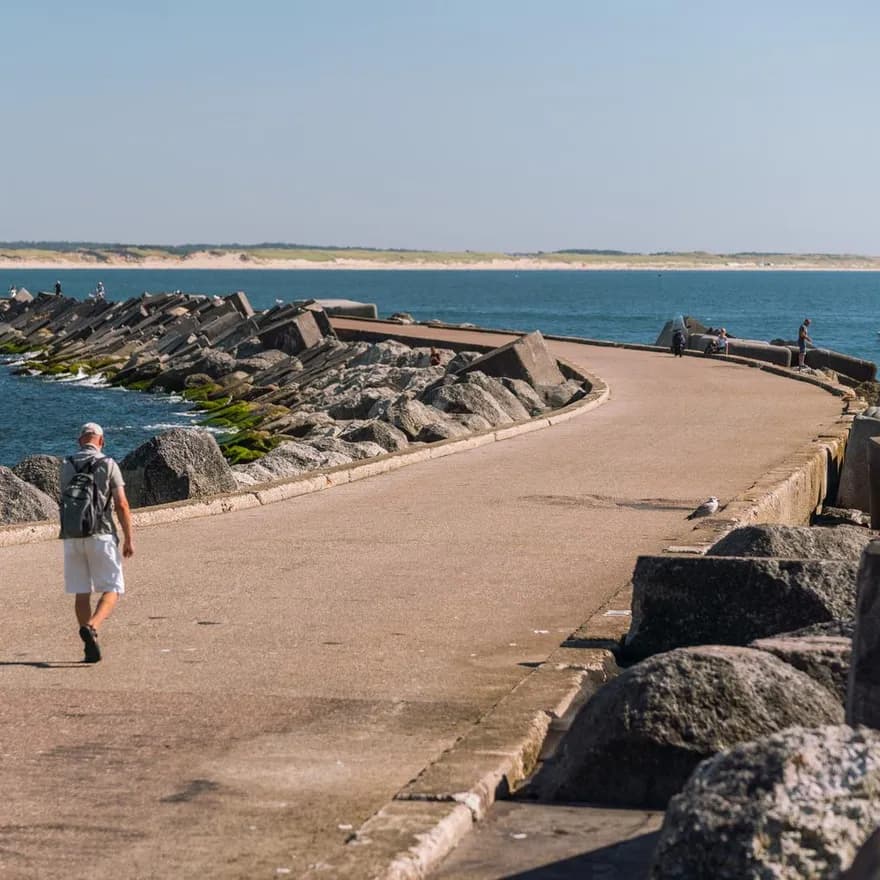 A man walking over Zuidpier IJmuiden.