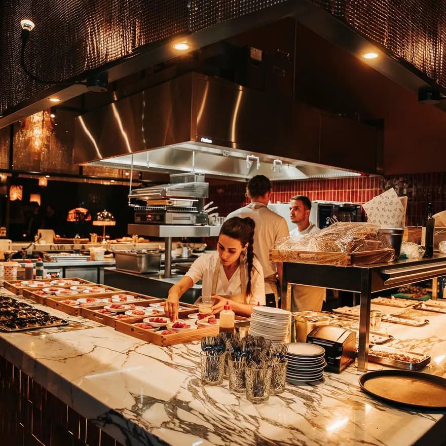 Chef preparing dishes at Hasta la Vista, Baby Spanish rooftop sky bar restaurant in Zuidas
