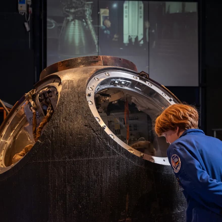 boy looking at astronaut exposition