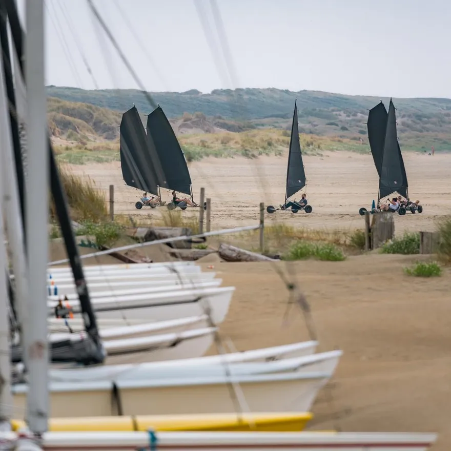 Boats in the sand and blowcarters at IJmuiderslag beach.