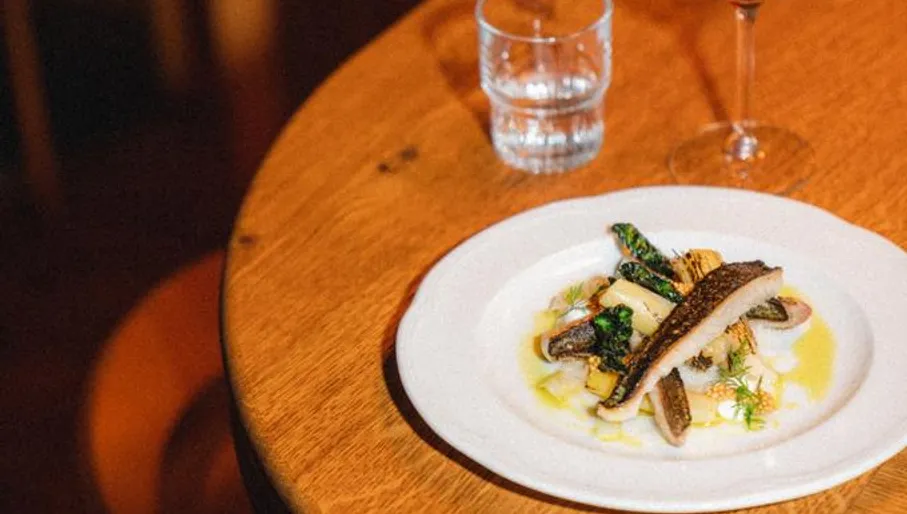 Restaurant De Tros Amsterdam East Oost interior. Fish on a plate with wine