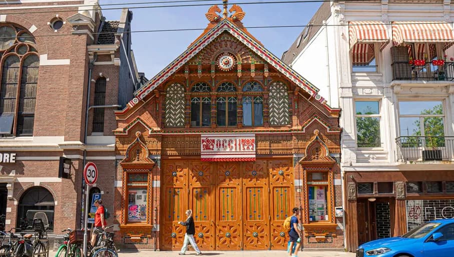 Colourful folk designs on the frontdoors of the OCCII concert and gig venue on Amstelveenseweg