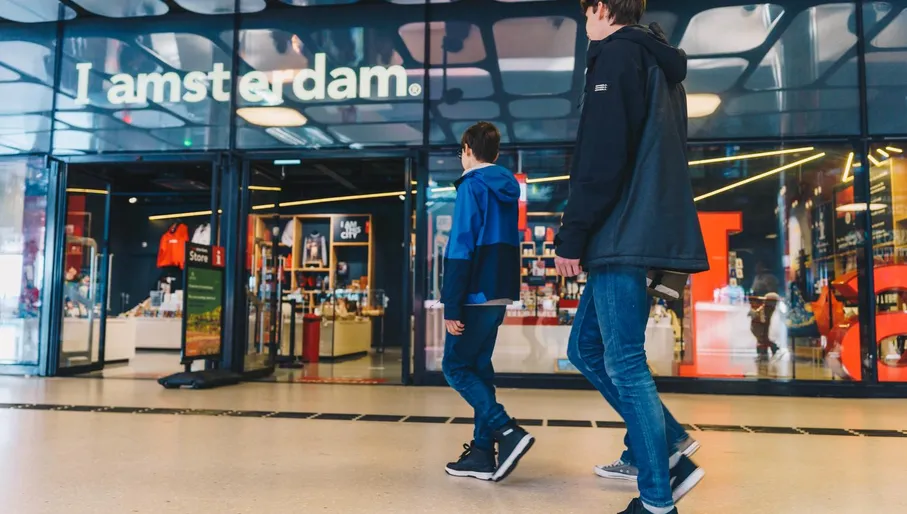 Two boys about to enter the Iamsterdam Store at Amsterdam Central Station.