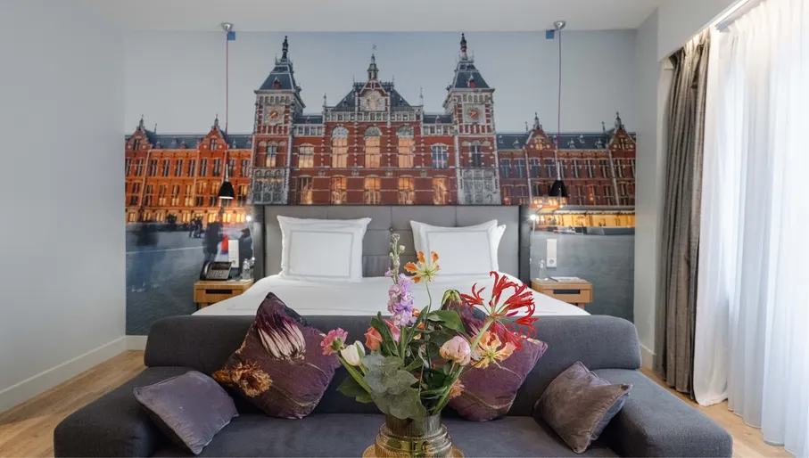 Swissôtel Amsterdam bedroom interior with photo mural of Amsterdam Central Station