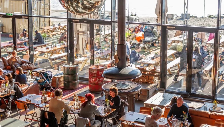 Pllek people sitting inside and out