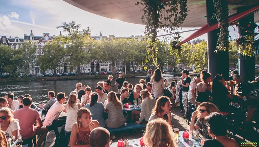 Waterkant people sitting on the terrace next to the water