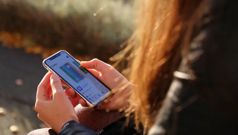Women holding smarthphone with Bunq application on the screen.