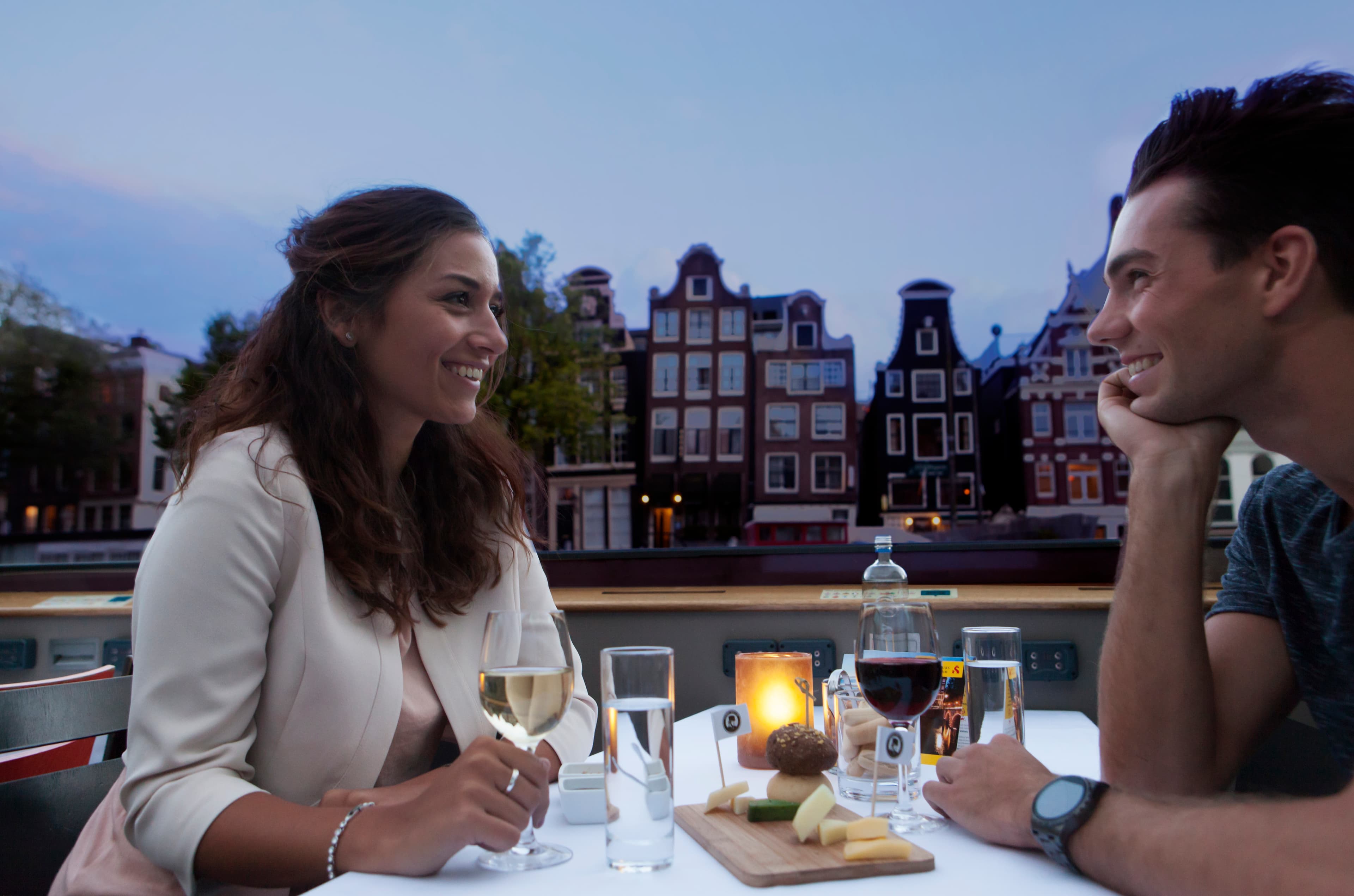 Dutch Cheese & Wine Cruise High wine on a canal cruise with Amsterdam in the background