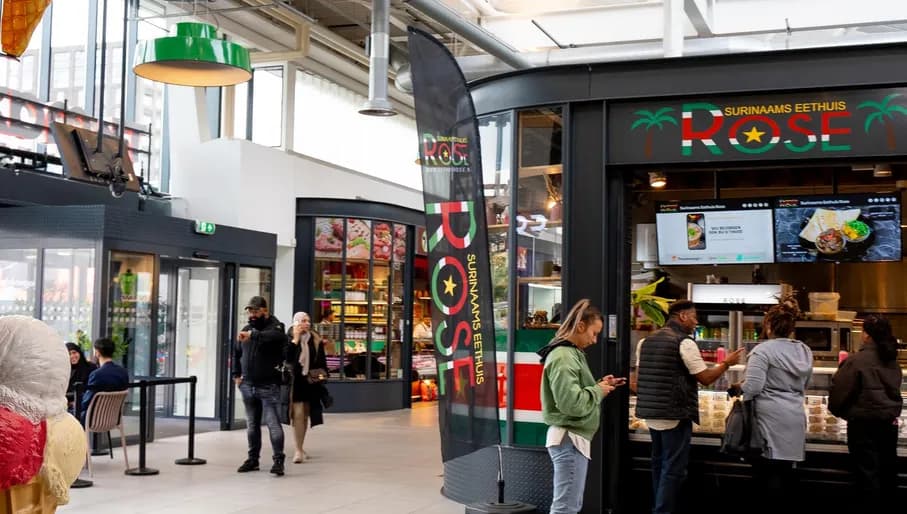 Westmarket shopping mall at Osdorpplein in Nieuw-West, food court and shops, interior surinamese takeaway and people standing in line
