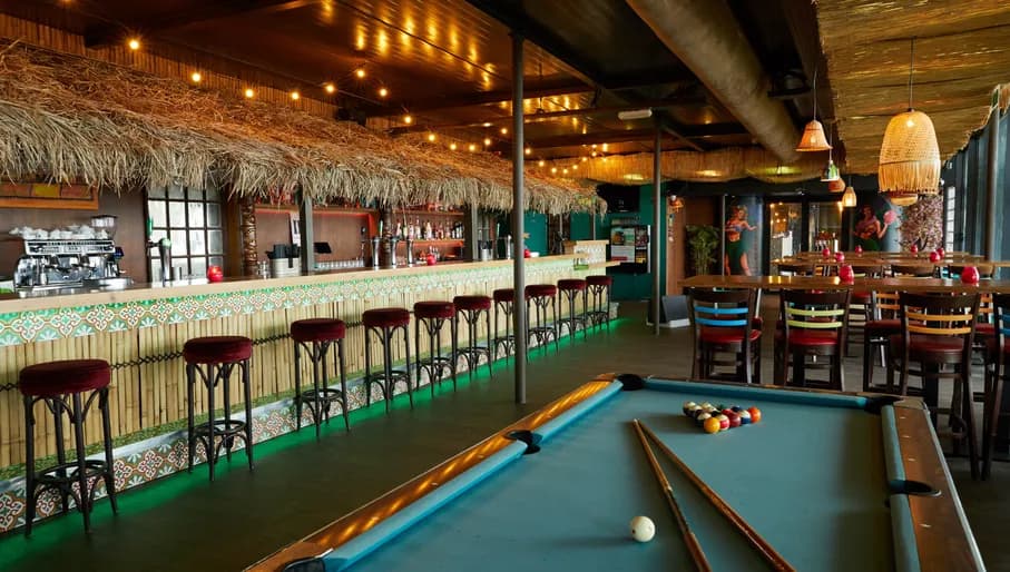 Aloha game center, Hawaii themed interior with bar and pool table
