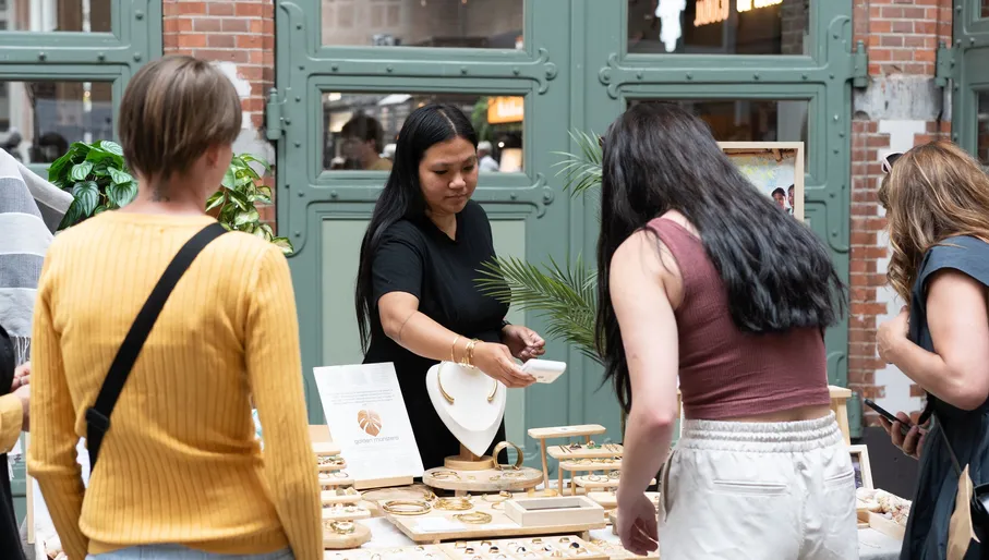 Women selling jewellery at the Maker Market in De Hallen